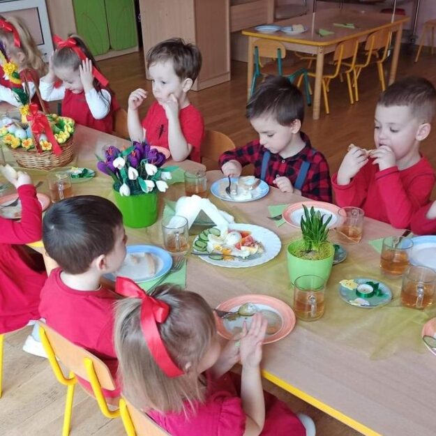 Dzieci siedzące przy stole na wspólnym śniadaniu