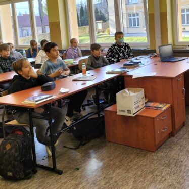 Uczniowie klas piątych w czasie pogadanki z policjantem