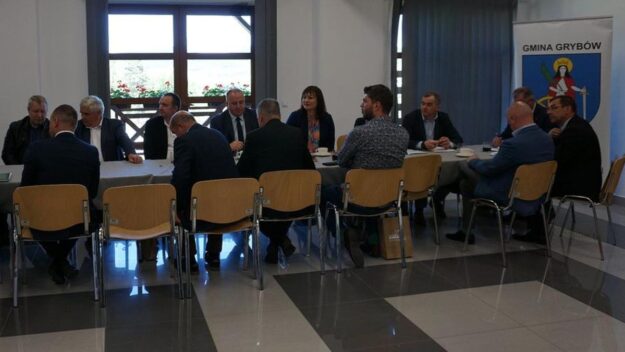 Widok na salę gdzie przy stołach ustawionych w rzędzie siedzą przedstawiciele samorządów będących członkami LGD